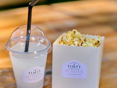 A branded Backyard BBQ Club cup and popcorn box