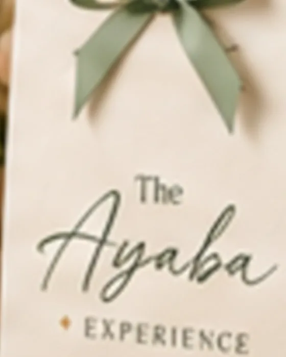 A personalised Ayaba celebration gift bag finished with a sage ribbon