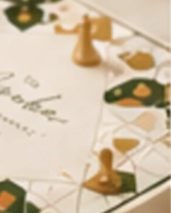 A personalised Ayaba Ludo set, showing the printed board and gold playing pieces
